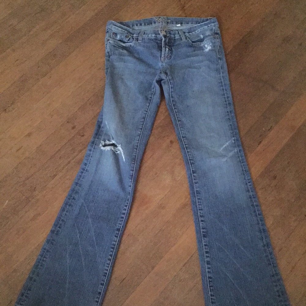 A pair of Bebe blue jeans